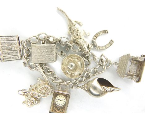 925 silver charm bracelet with nine charms to include clock and shell, L: 22 cm, combined 65g. P&amp;P Group 1 (£14+VAT for t