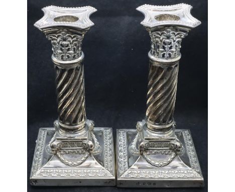 Pair of hallmarked silver columnar candlesticks with twist stem and capital terminations, each H: 18 cm (filled). P&amp;P Gro