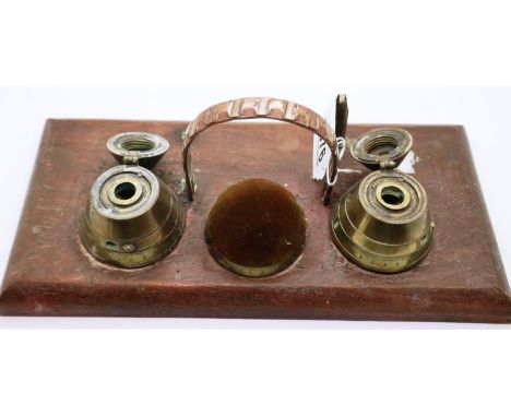 A trench art desk stand comprising two shell fuses converted to inkwells and blotter, with faults.  P&amp;P Group 2 (£18+VAT 