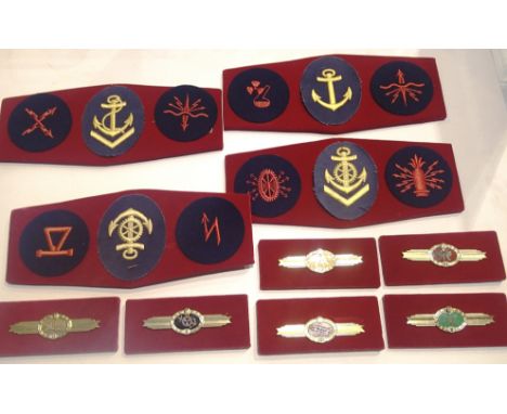 Collection of board mounted East German Naval Division patches (12) together with six award clasps. P&amp;P Group 1 (£14+VAT 