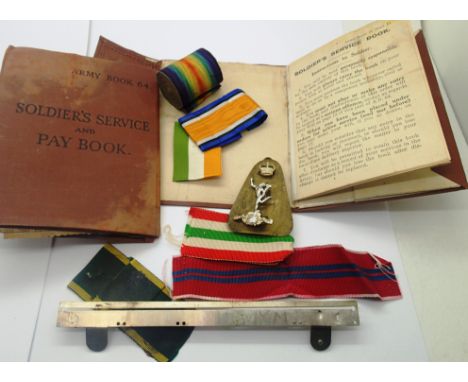 Mixed original ribbons including a roll of WWI Victory ribbon together with two soldiers service pay books. P&amp;P Group 1 (