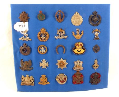 A display board of military cap badges including Queens Lancers and Womens Land Army