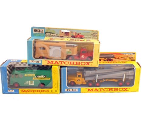 A boxed Matchbox king sized K5 racing car transporter, K18 articulated horse van and K10 pipe truck, red wheels and grey pipe