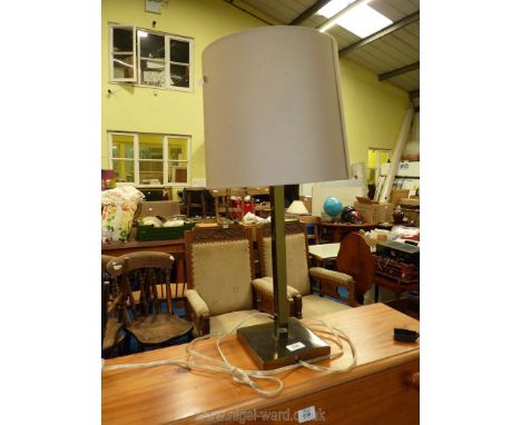 A square metal based table lamp and shade.