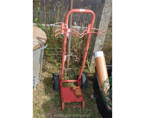 A long handled fork plus a bottle carrier trolley.