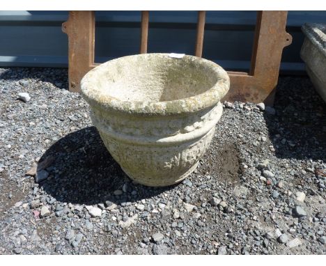 A rounded concrete planter, 13" diameter x 10" high.