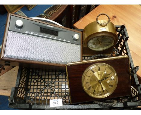 Two clocks and a Polaroid radio.