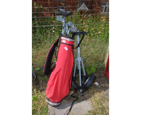 A golf caddy and trolley with clubs including Howlson, etc. 