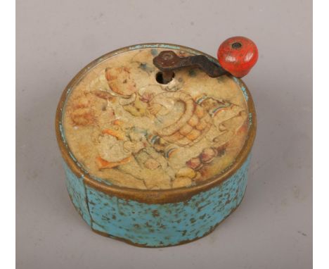 A Manivelle circular music box, with lithograph of children at play.  Working condition.