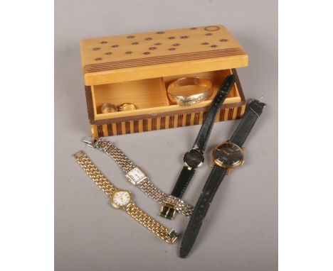 A wooden jewellery box to include quartz wristwatches, rings, bangle.  