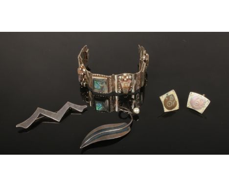 Two modernist brooches, a pair of earrings and a panel brooch set with abalone shell. All marked Taxco, Mexico.  
