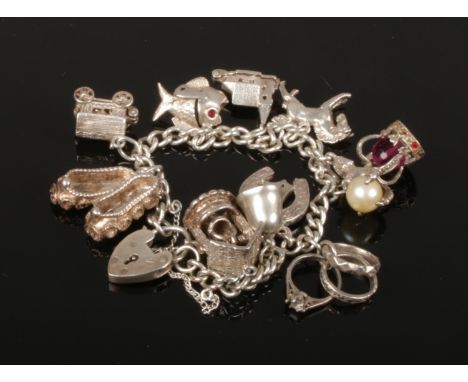 A silver charm bracelet with heart shaped clasp, 43.7 grams gross.  