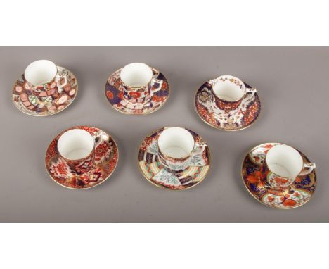 A collection of Royal Crown Derby, Imari coffee cans and saucers.  