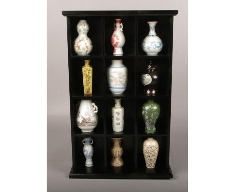 A display of miniature ceramic vases.  