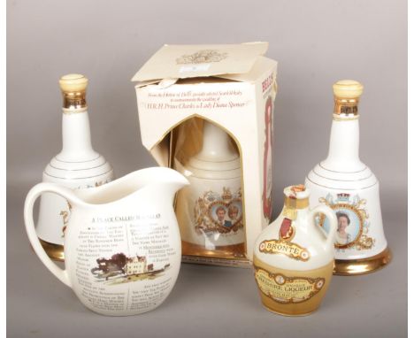 Three Wade Bells whisky decanters, full and sealed, one boxed. A flagon of full and sealed Yorkshire liqueur and a 'Place Cal