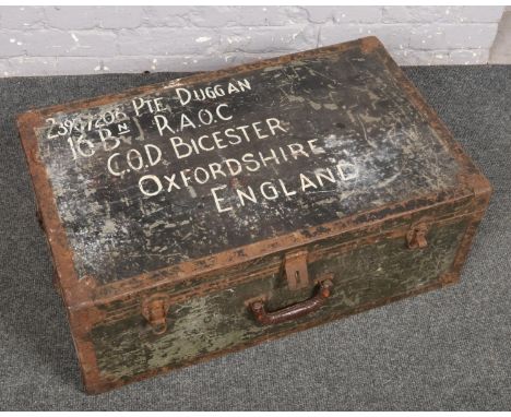 A military trunk with soldiers particulars inscribed and containing a collection of vintage ice skates.  
