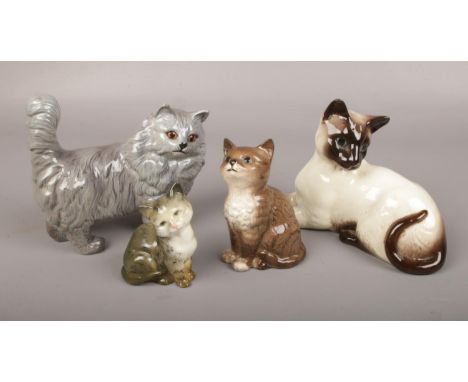 Four Beswick ceramic figures of cats.  Good condition.