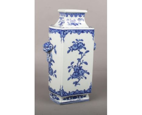 A Chinese blue and white kong vase. With moulded mask and loop handles and painted in underglaze blue with fruiting branches 