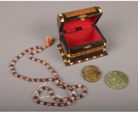 A wooden box containing two carved Jade discs &amp; Sandlewood/rock crystal Tibetan prayer beads  