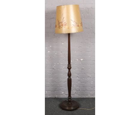 A carved mahogany standard lamp on circular base.  