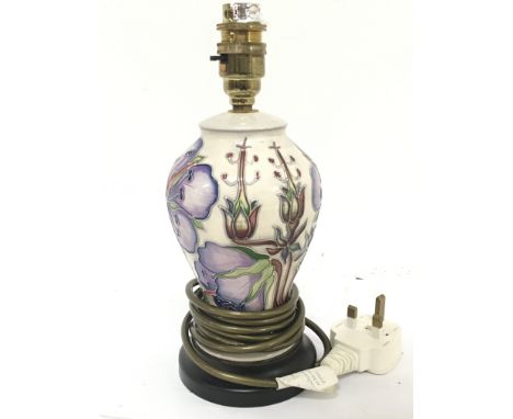 A small Moorcroft lamp fitted for electric high 26cm