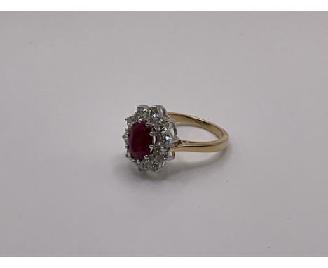 A certified 18ct white and yellow gold oval cut ruby and diamond cluster ring, 1.50ct Ruby, 1.50ct Diamonds.