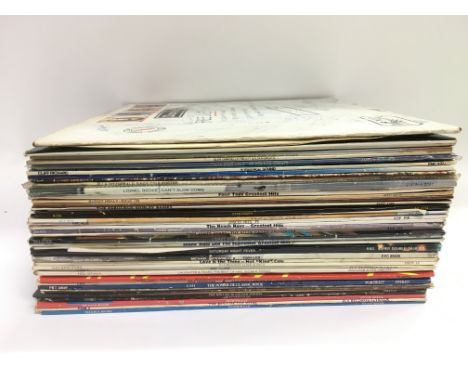 A collection of LPs by various artists including Free, Paul McCartney, Michael Jackson and others.