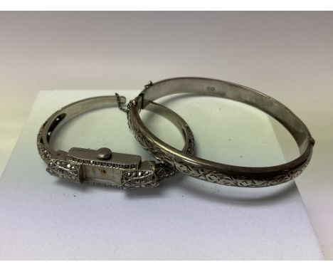 A vintage sterling silver bangle watch together with a silver engraved bangle.