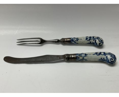 A Bow knife and fork with three teeth, soft porcelain handle decorated in monochrome blue Steel blade and silver collars.