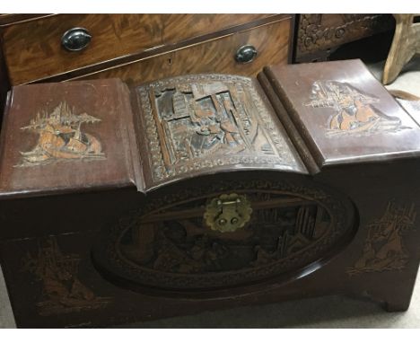 A carved and shaped camphor wood trunk with brass fittings. Length 90cm
