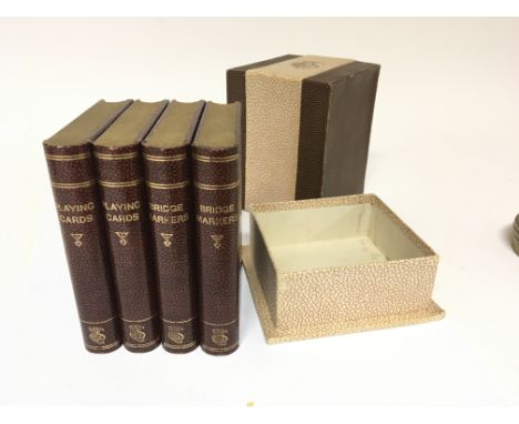 A Vintage unopened bridge set in the form of books each containing playing cards and note pads in an outer fitted box.
