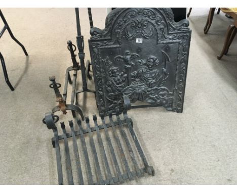 An 18th century cast iron fire back of classical design. With a fire grate and wrought iron fire side ornaments.