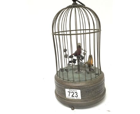 A singing bird automata clock work movement with two feathered birds in a dome cadge.seen working height 28cm