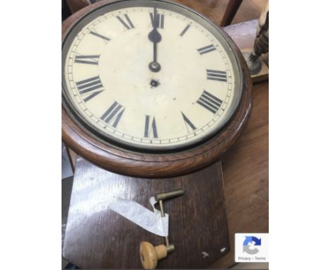 An oak drop dial wall clock with circular dial and Roman numerals.