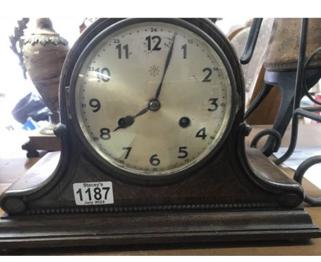 An Oak clock with silvered dial and Arabic numerals.