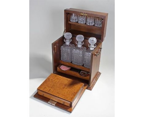 20th Century oak decanter and games compendium box with three hob nail design decanters and four glasses on swinging tray rec