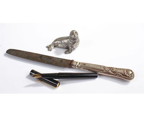 Model of a seal, in white metal, together with an Osmiroid fountain pen and a silver handled knife, (3)