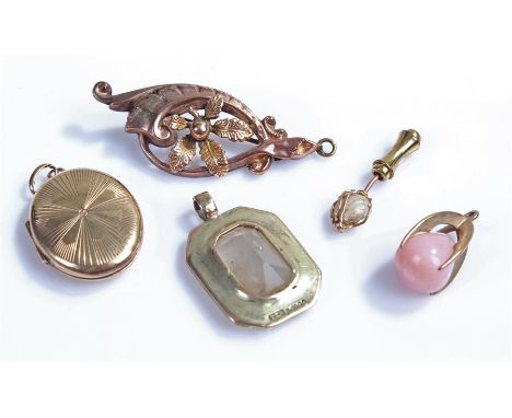 Jewellery, to include two pendants with 9 carat gold mounts, a 9 carat gold brooch a 9 carat gold locket and a stick pin top,