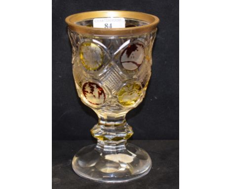 A Bohemian ruby and amber cut and flashed glass goblet, with gilt rim, 18 cm high