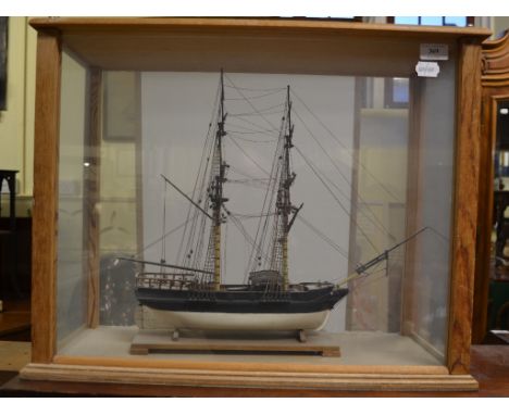 A wooden model of a two-masted ship, cased, 61 cm wide