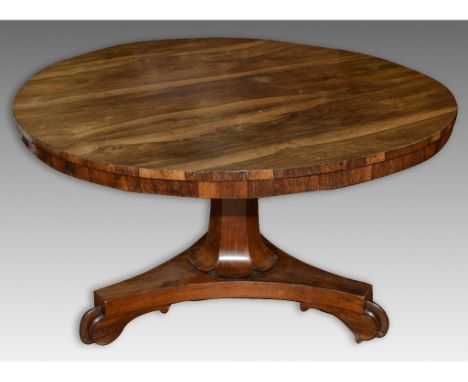 A Victorian rosewood circular tilt top breakfast table, on a triform platform base, 129 cm diameter  See illustration   Condi