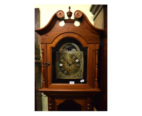 A modern longcase clock, fitted a movement with a 25 cm brass dial with Roman numerals, 210 cm high 