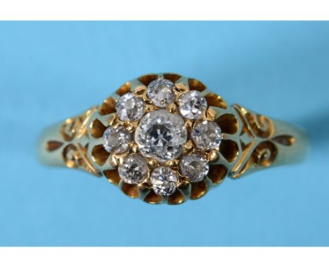An 18ct gold and diamond flowerhead ring, inscribed and dated 26/9/07, approx. ring size O½  See inside front cover colour il