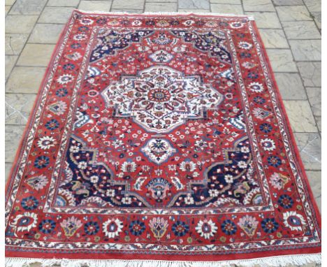 A Persian Bakhtiari carpet, with central medallion on a multi coloured ground, within a multi border, 343 x 254 cm