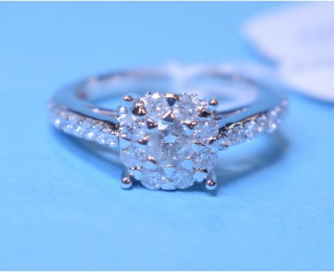 A 9ct white gold and diamond cluster ring, with diamond set shoulders, approx. ring size M Condition report Modern