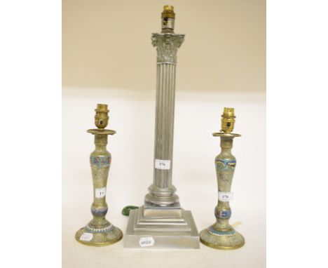 A Hinks table lamp, in the form of a Corinthian column, 47.5 cm high (excluding fitment), a pair of champlevé enamel candlest