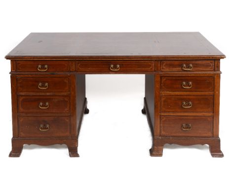An Edwardian inlaid pedestal desk, having an arrangement of nine drawers, on swept bracket feet, 160 cm wide  See illustratio