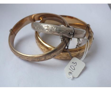 A silver bangle and 2 gilt bangles     