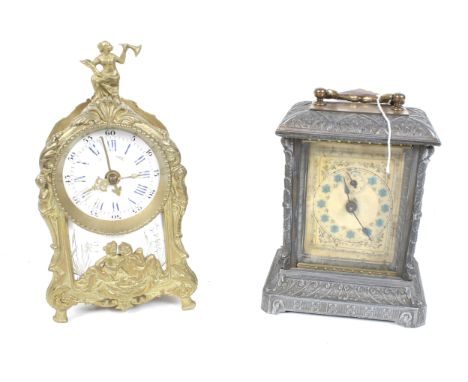 Two mantel clocks. Including a cast brass alarm clock with decorative enamel panel, classical nude figures, scrolls and mask,