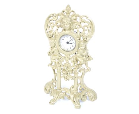 A painted cast spelter cased mantel clock. With cherubs, a mask, floral and scroll decoration. White dial with Arabic numeral